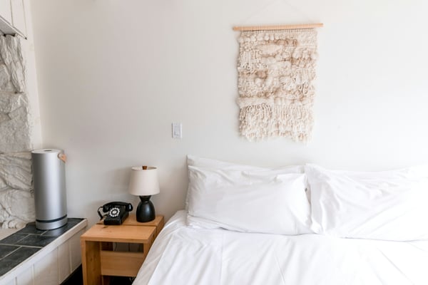 Warm, airy bedroom with fresh white linen and natural light