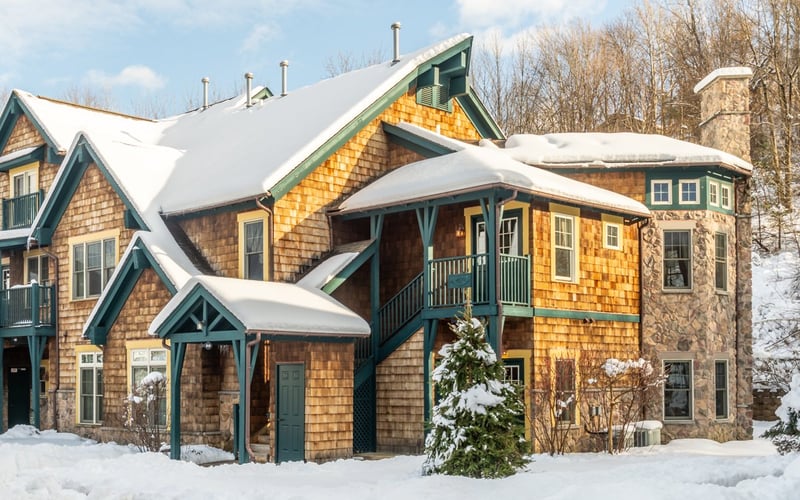 Condos at the Creek exterior in winter with bare trees