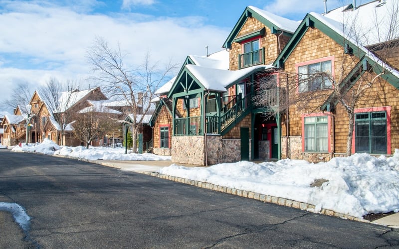 Winter exterior of Condos at the Creek with snow-covered grounds