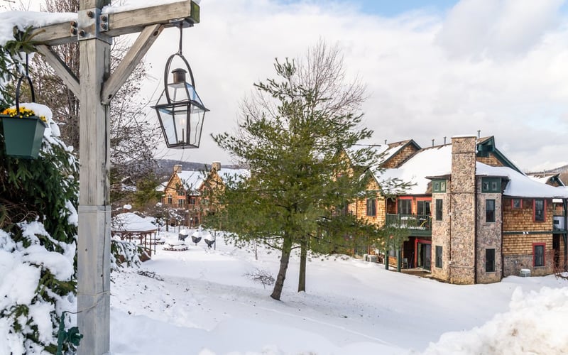Snow-covered walkway between townhomes at Condos at the Creek