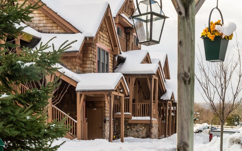 Snow-covered townhome exterior at Condos at the Creek