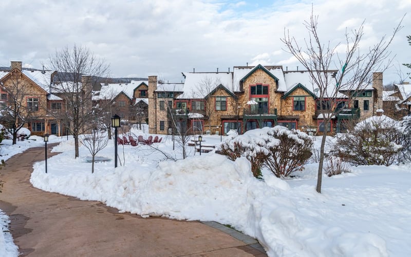 Townhome exterior with snow-covered grounds at Condos at the Creek