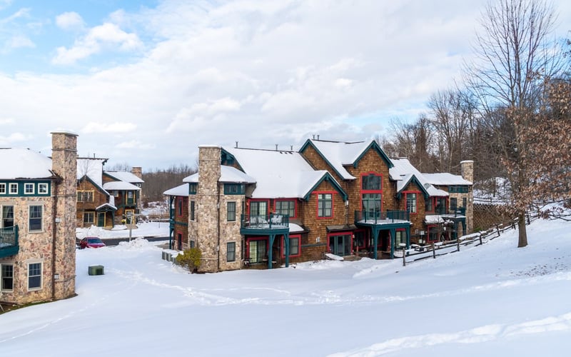 Snow-covered townhome exterior at Condos at the Creek